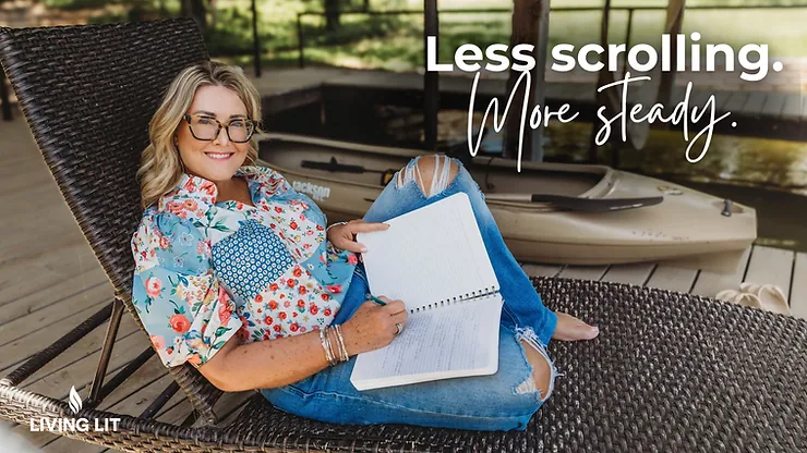 A photo of Michelle sitting outdoors in a patio chair. She's smiling at the camera, writing in her journal, and wearing blue jeans and flowered shirt.