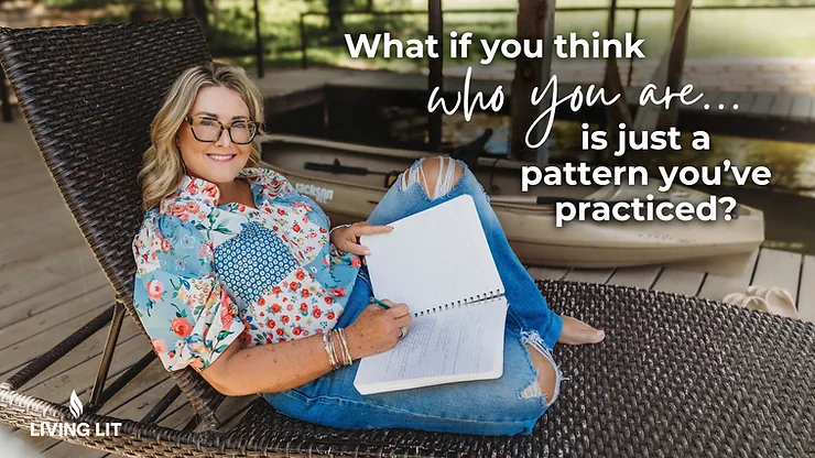 Michelle, sitting in a patio chair in a flowered shirt and blue jeans while she smiles at the camera and holds her journal.