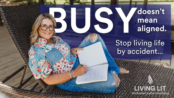Smiling woman in glasses reclines on wicker chair with notebook; bold text says BUSY doesn’t mean aligned. Stop living life by accident...