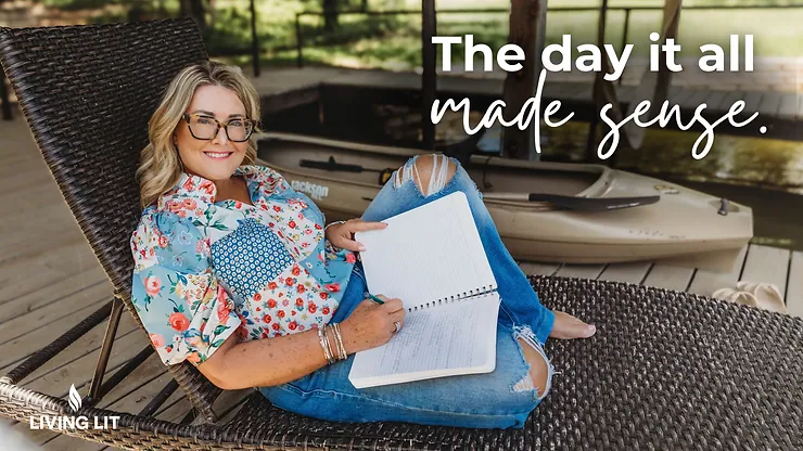 Michelle sitting in a chair outside writing in her notebook smiling at the camera